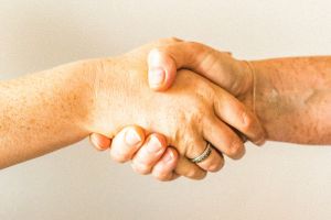 Zwei Hände geben sich die Hand